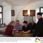 Carol Stanton, John Stanton, Theodor Valentin Purcarea, and Nicolae Albu sitting quietly in the old Anton Pann classroom of the First Romanian School